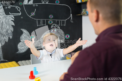 Image of Cute little toddler boy at child therapy session.