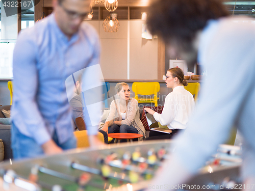 Image of Office People Enjoying Table Soccer Game