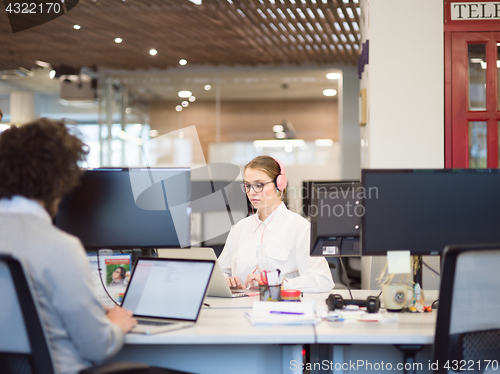 Image of businesswoman using a laptop in startup office