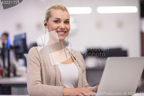 Image of businesswoman using a laptop in startup office