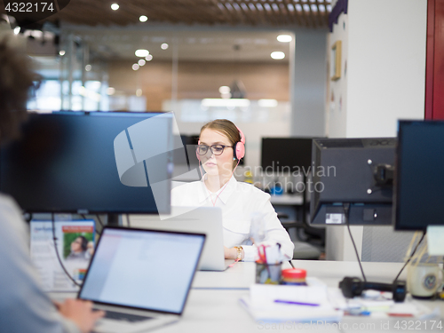 Image of businesswoman using a laptop in startup office