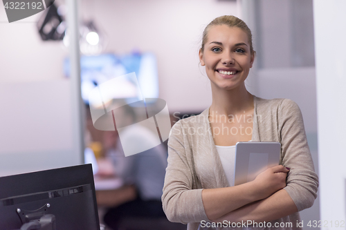 Image of Business Woman Using Digital Tablet in front of startup Office