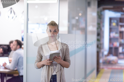 Image of Business Woman Using Digital Tablet in front of startup Office