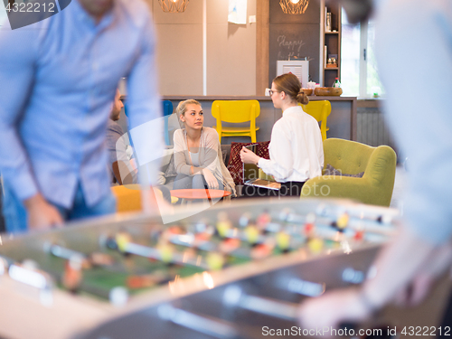 Image of Office People Enjoying Table Soccer Game