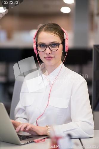 Image of businesswoman using a laptop in startup office