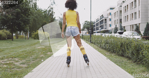 Image of Girl in rollers at street