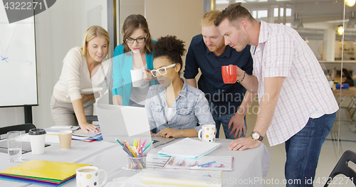 Image of People watching laptop with interest