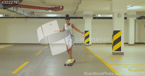 Image of Girl skateboarding on parking