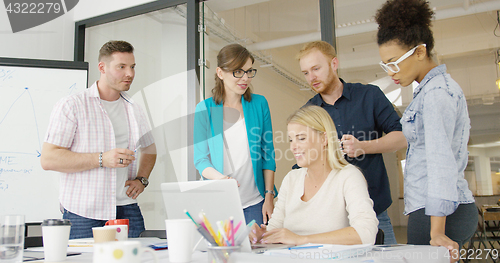 Image of Coworkers with laptop in office