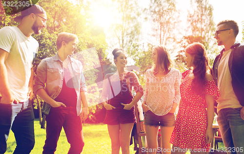 Image of happy teenage friends talking at summer garden