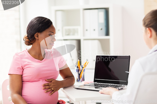 Image of doctor with laptop and pregnant woman at clinic