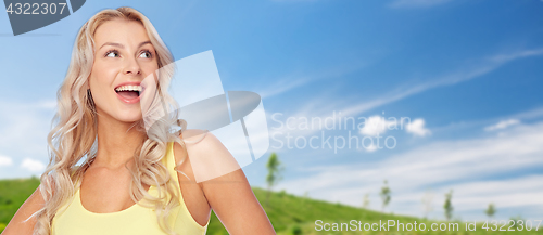 Image of smiling young woman with blonde hair in summer