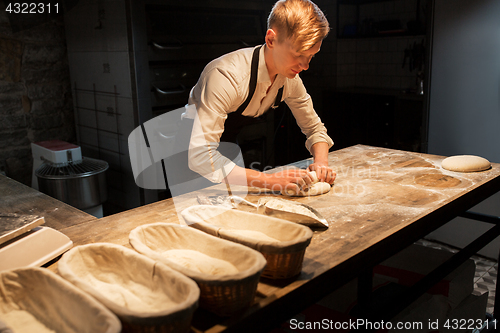 Image of chef or baker making dough at bakery