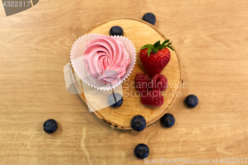 Image of zephyr or marshmallow with berries on stand