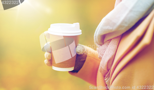 Image of close up of woman with coffee in autumn park