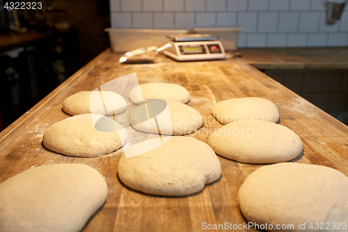 Image of yeast bread dough on bakery kitchen table