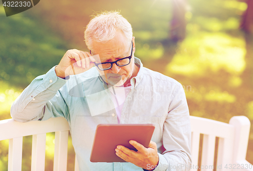 Image of senior man with tablet pc at summer park