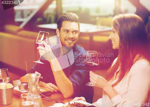 Image of couple dining and drinking wine at restaurant