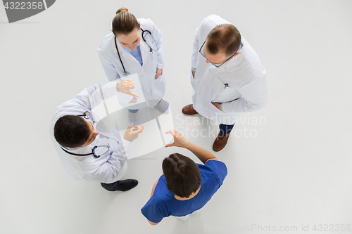 Image of doctors working with something imaginary at hospital