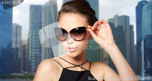 Image of beautiful young woman in elegant black sunglasses