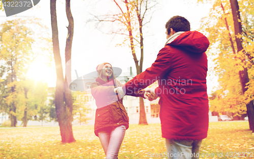 Image of happy young couple having fun in autumn park