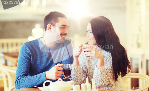 Image of happy couple drinking tea at cafe