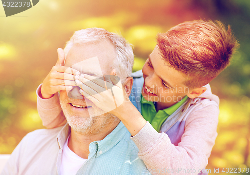 Image of grandfather and grandson playing at summer park