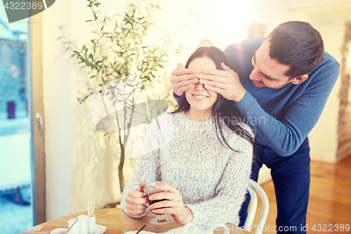 Image of happy couple drinking tea at cafe