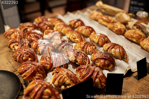 Image of sweet buns with price tags at bakery store