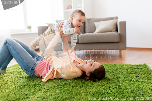 Image of happy young mother playing with baby at home