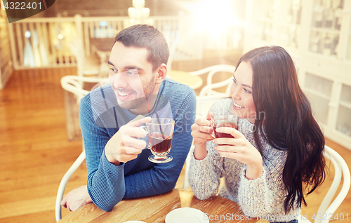 Image of happy couple drinking tea at cafe