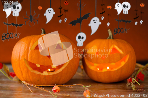 Image of carved pumpkins in witch hat and halloween garland