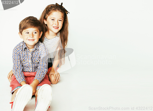 Image of little cute boy and girl hugging playing on white background, ha