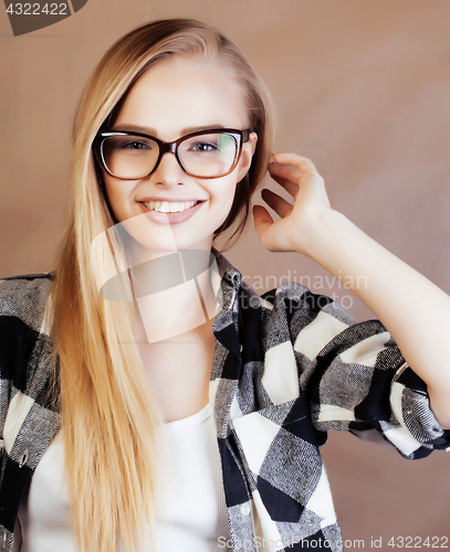 Image of young pretty blond woman with smartphone posing smiling, making 