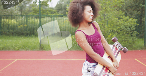 Image of Trendy model posing with longboard