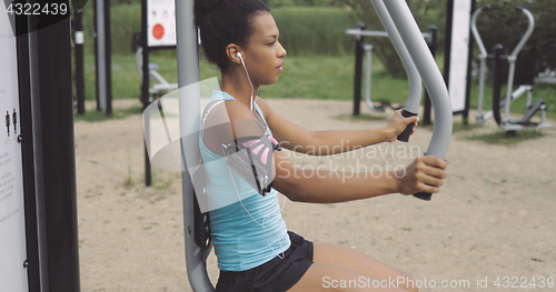 Image of Sportswoman training in park