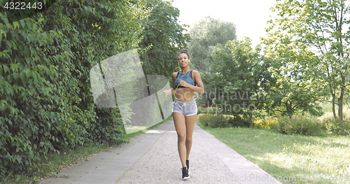 Image of Content woman running in park