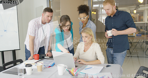 Image of Coworkers with laptop in office