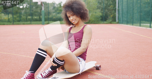 Image of Cheerful model posing on longboard