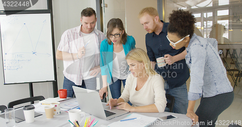 Image of People in office watching laptop