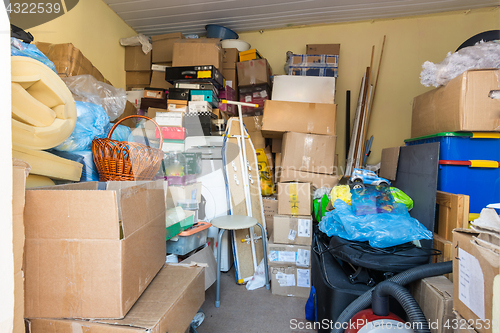 Image of Moving, things packed in boxes and packages lie in a small room