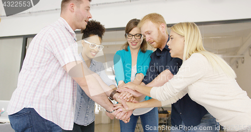 Image of People stacking hands for team