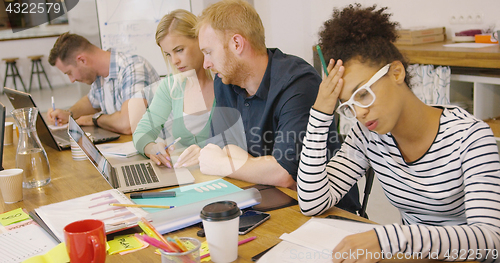 Image of Young people working hard in office