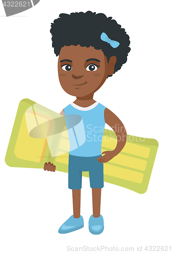 Image of Little african girl holding inflatable mattress.