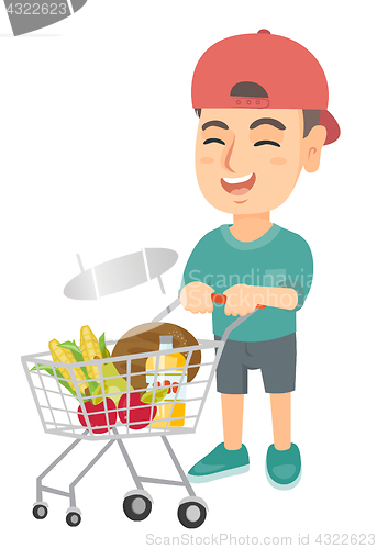 Image of Little caucasian boy with his shopping trolley.