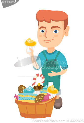 Image of Boy holding a cupcake and stroking his belly.
