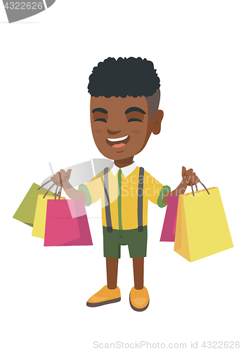 Image of Happy african-american boy holding shopping bags.