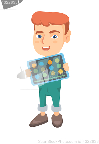Image of Caucasian boy playing game on a tablet computer.