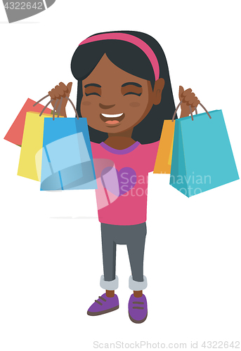 Image of Happy african-american girl holding shopping bags.