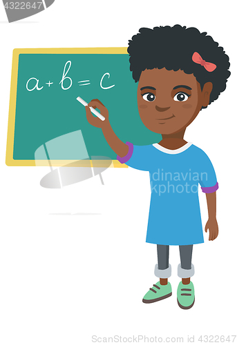 Image of African schoolgirl writing on the blackboard.